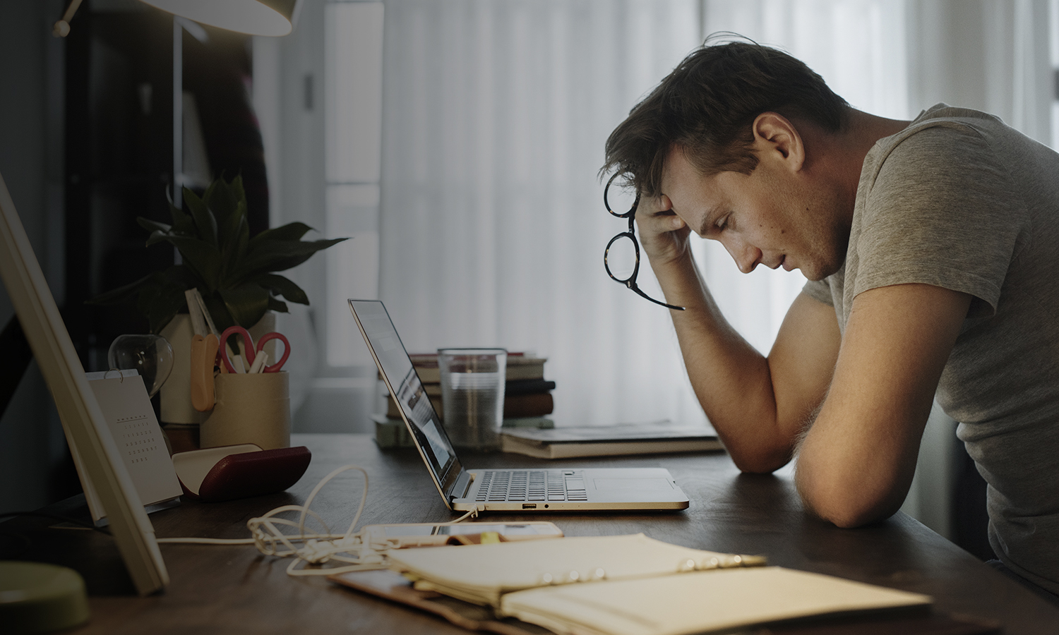 frustrated man at desk looking over financial records