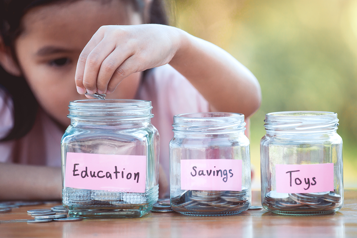 A child saving change in marked jars