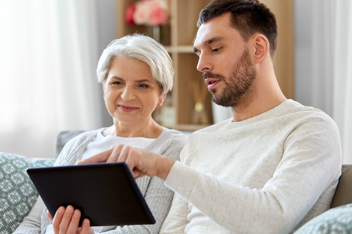 Young man helping senior adult