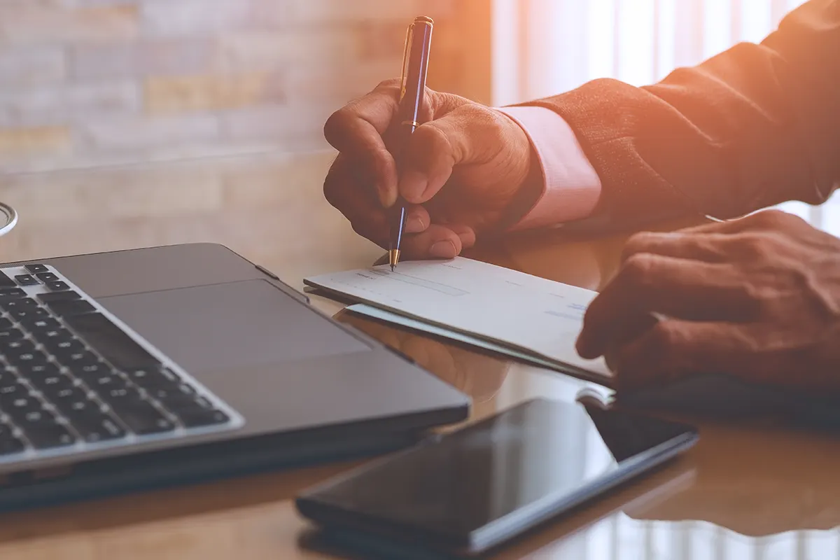 Hands writing a check