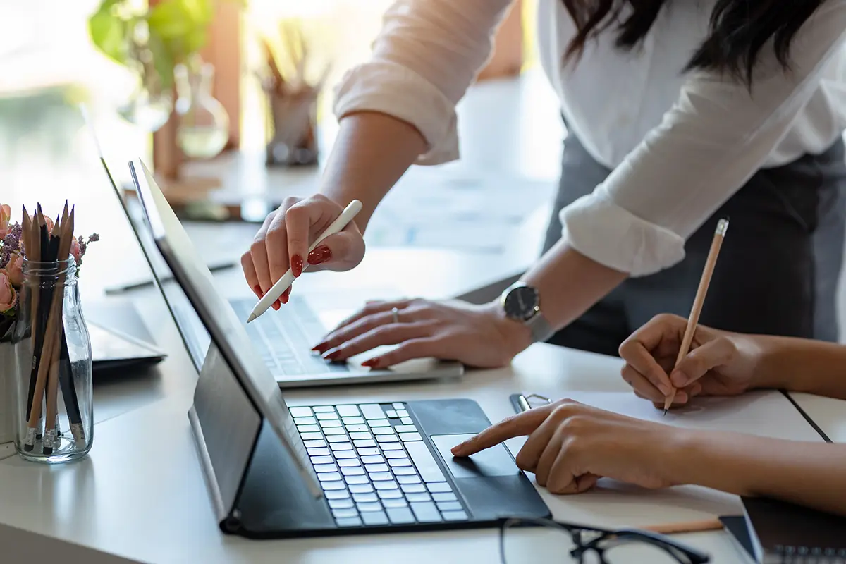 Two people working on a tablet
