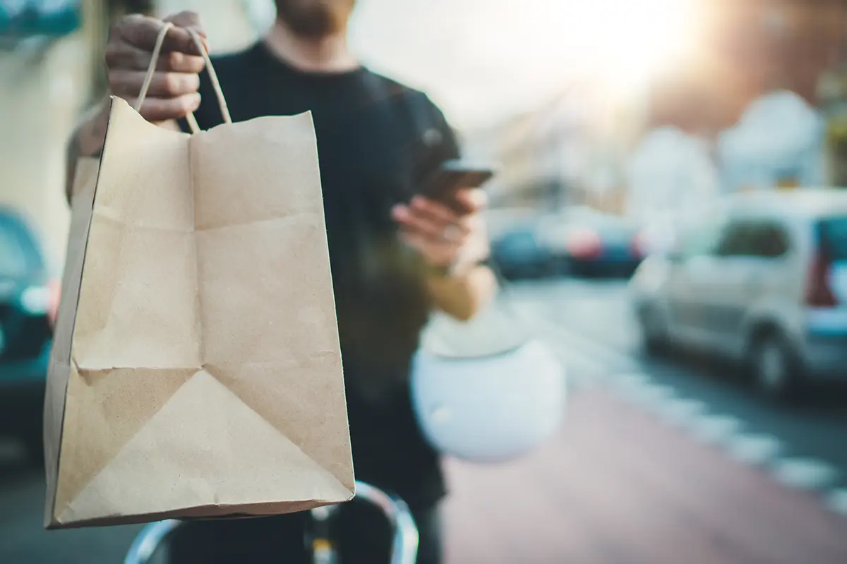 Food being delivered in a brown paper bag